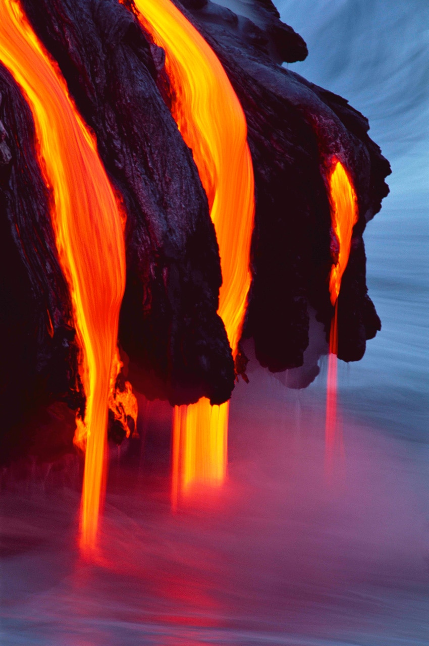 Lava flows gently into the Pacific Ocean in this photo by Brad Lewis. Kilauea is the most active volcano on Earth.