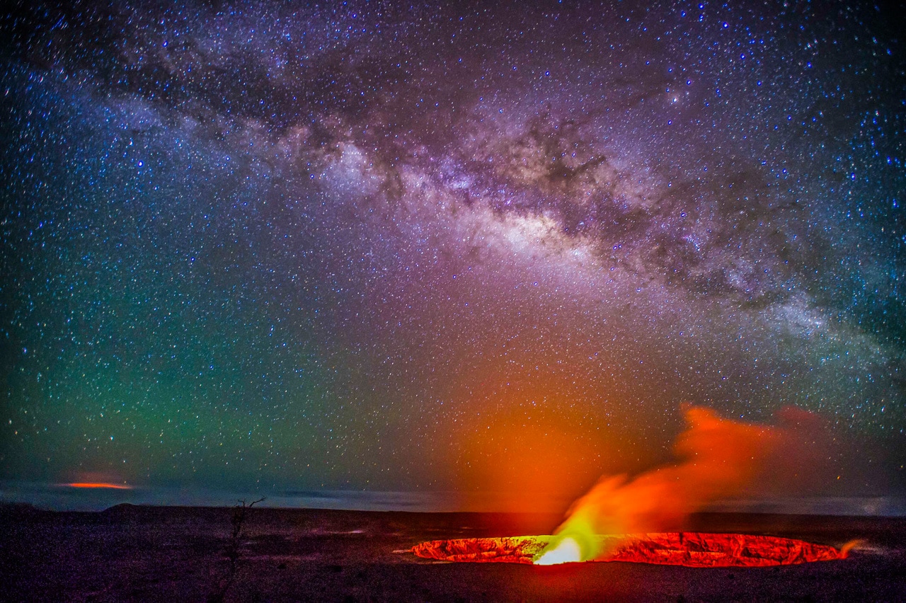 The Kilauea Volcano glows at night below the Astreas Galaxy in this photo by Brad Lewis. Kilauea is the most active volcano on Earth.