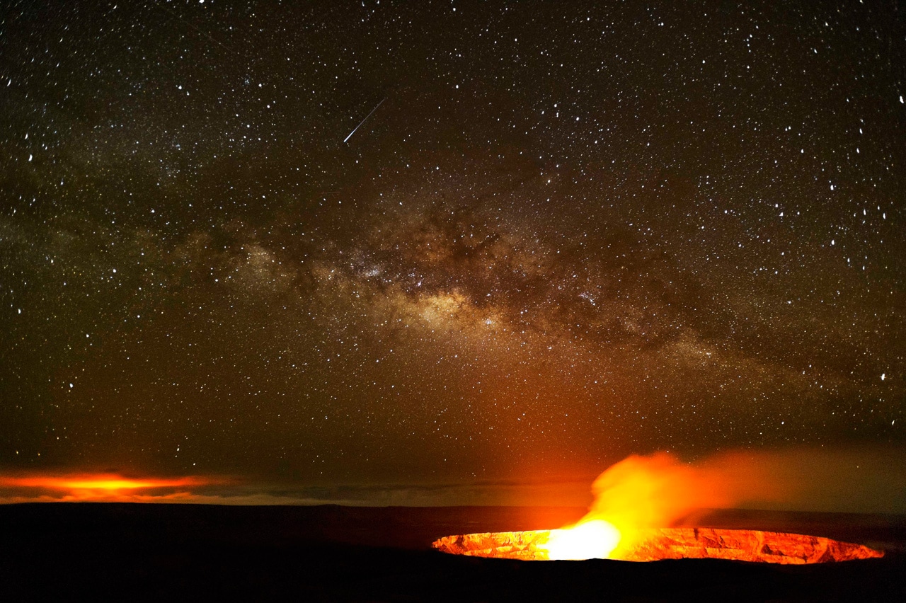 A comet shines above the Kilauea Volcano on Hawaii in this photo by Brad Lewis. Kilauea is the most active volcano on Earth.