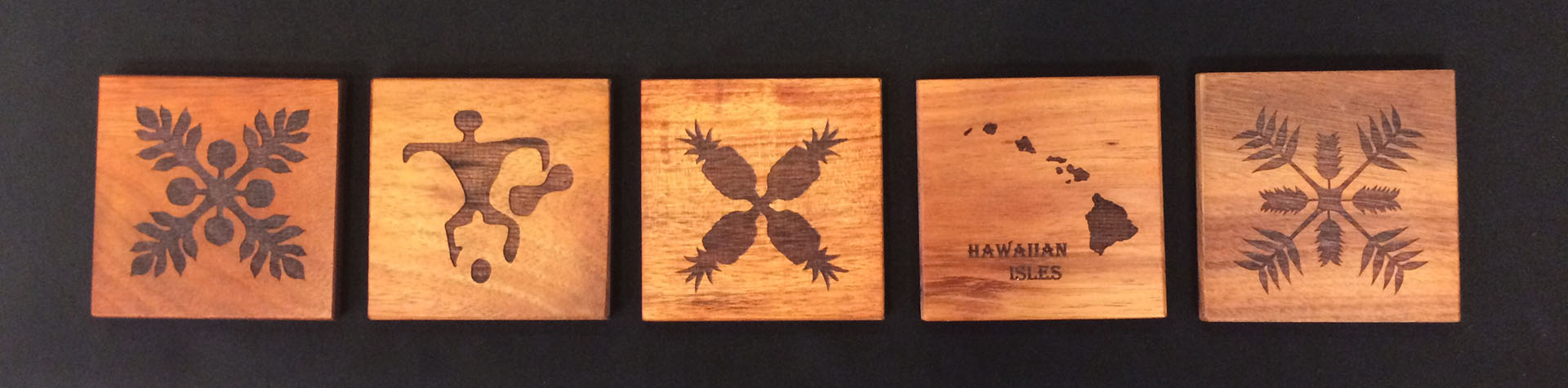 Five Engraved Koa Coasters with different designs