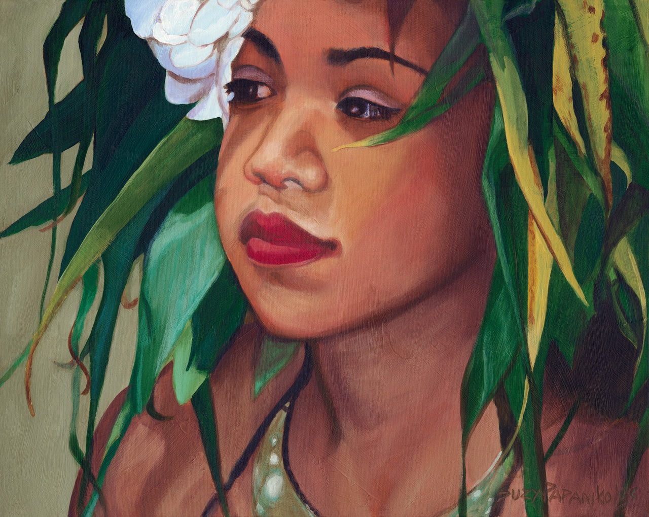 Portrait of a young hula girl with a ti leaf haku and white plumeria flowers in her ear