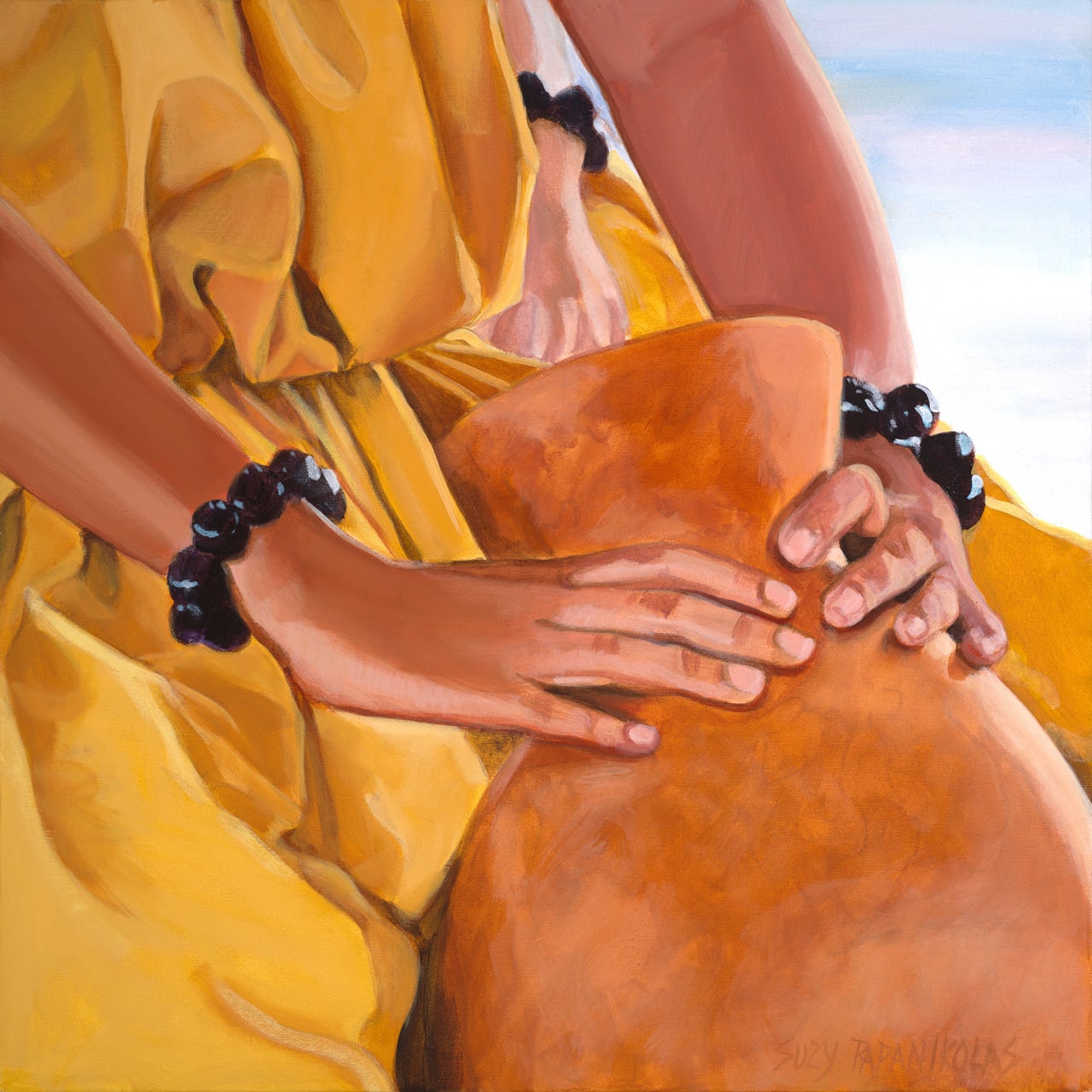 The hands of a young hula dancer wearing yellow holding an ipu