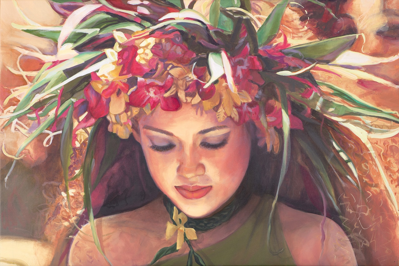 The face of a young hula dancer looking down, wearing a yellow and pink orchid haku