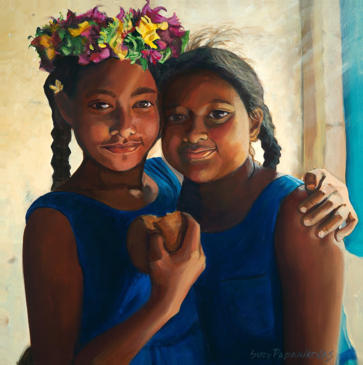 Two young girls looking straight on, smiling and holding a donut. Wearing blue