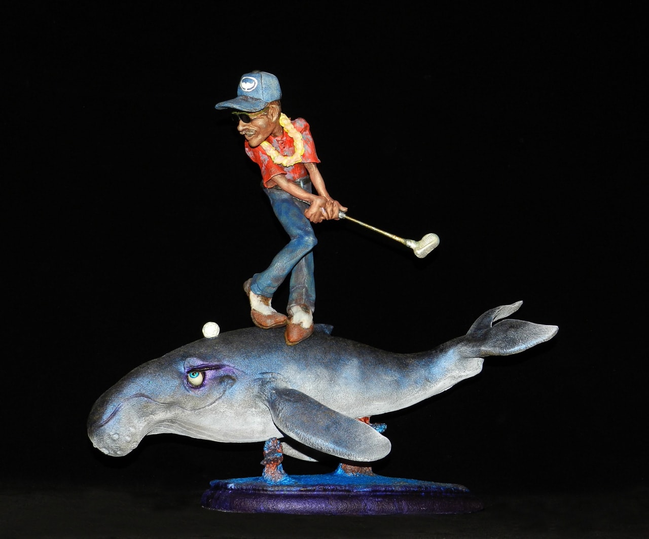 Water Hazard by Steven Lee Smeltzer cartoonish whimsical clay sculpture of golfer on whale