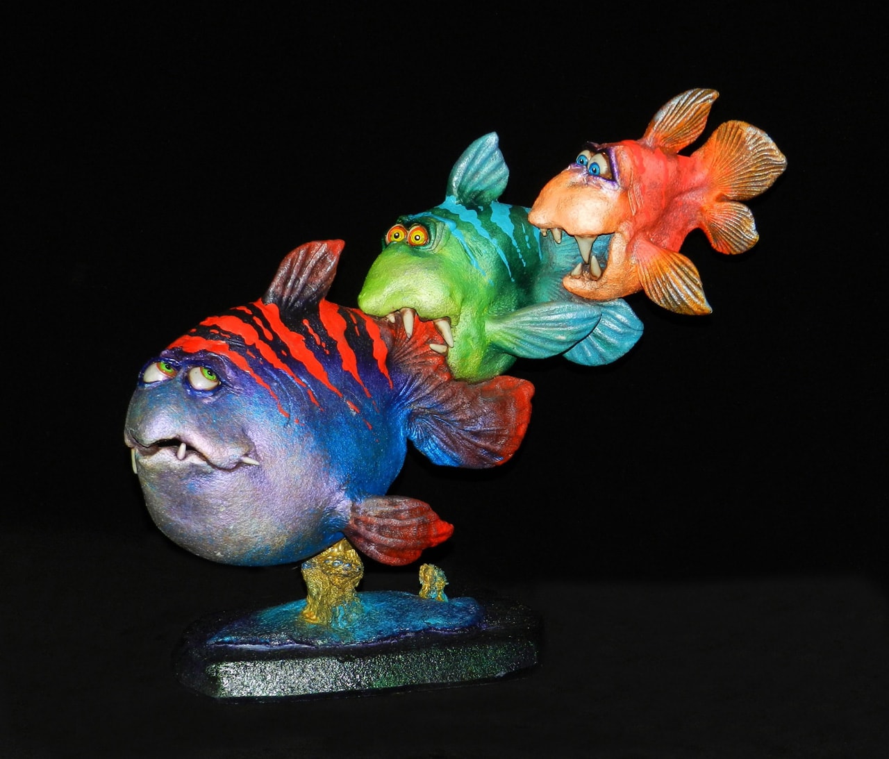 Optimist by Steven Lee Smeltzer cartoonish whimsical clay sculpture of three fish eating each other