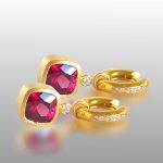 Small gold hoops with diamonds and magenta stones hanging