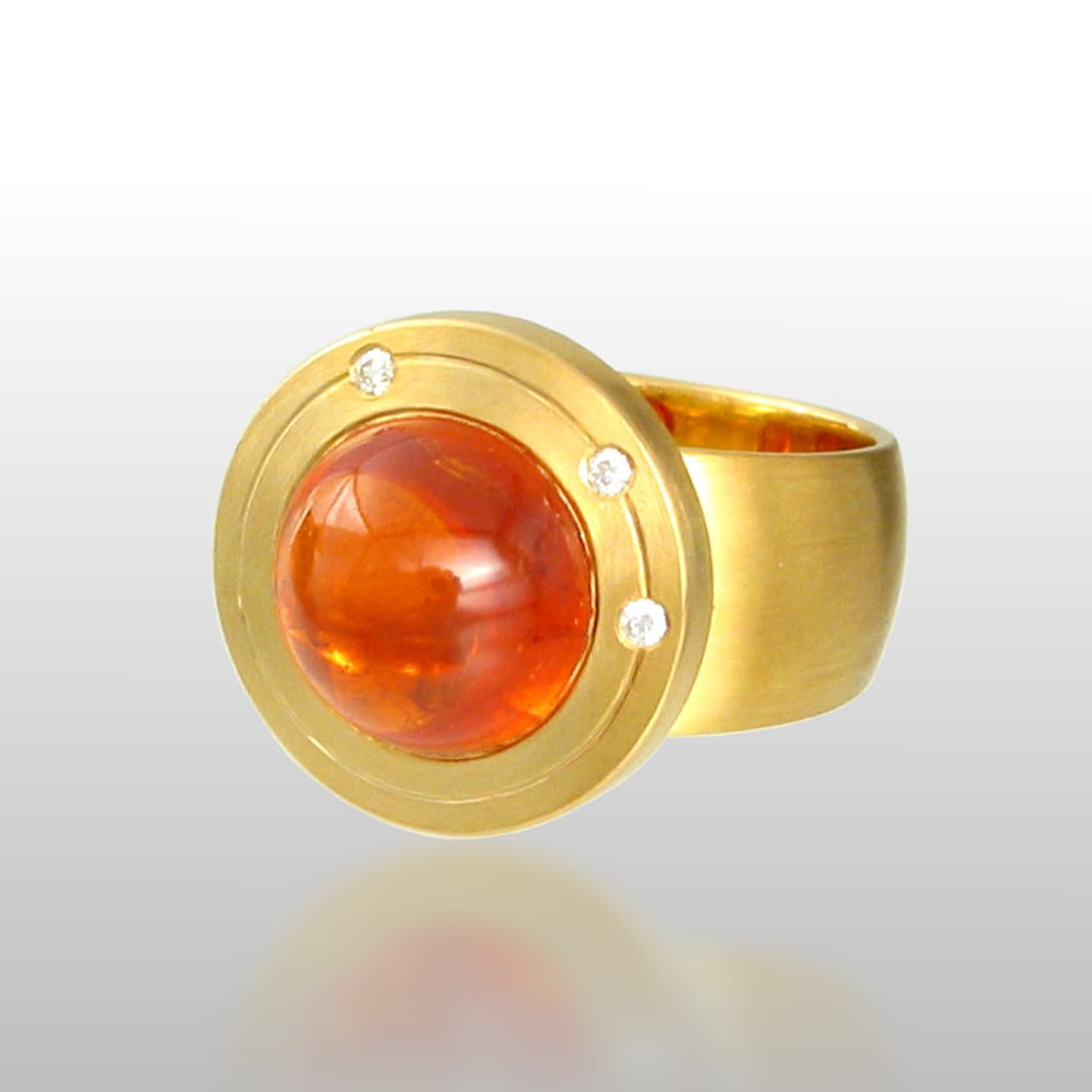 18k Yellow gold ring with a wide band and a round orange stone with 3 diamonds above the stone