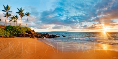 Seascape photo of a beach in Wailea, Maui while the sun sets over the ocean