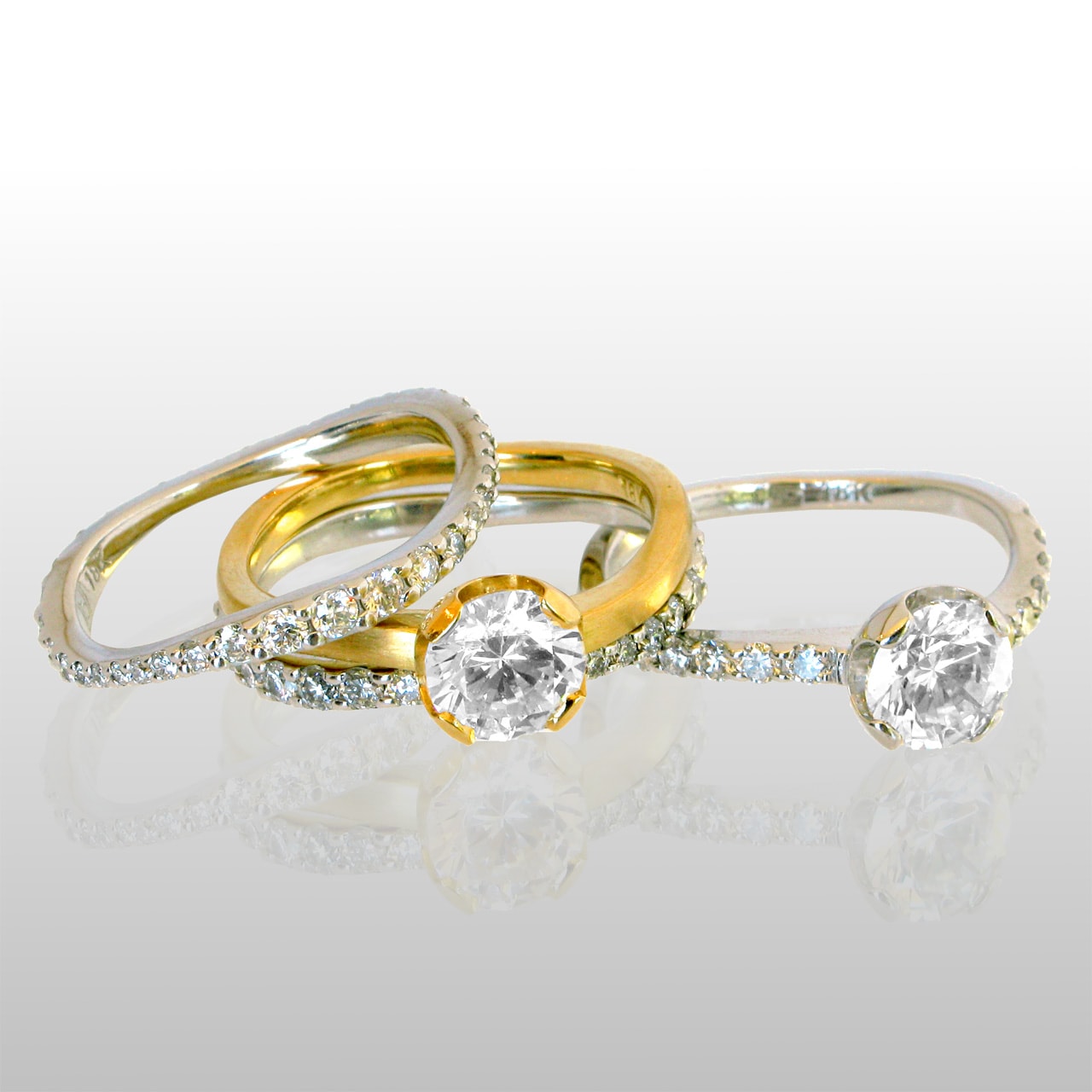 Four wedding rings, two solitaire diamond rings and 2 band rings with diamonds all around. Made of 18k gold