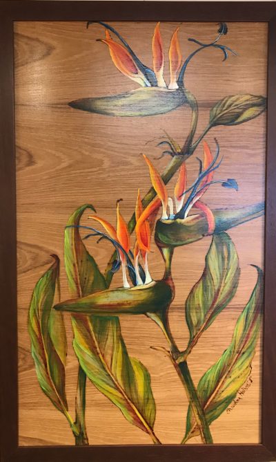 A wood burned and oil painted wood panel of three birds of paradise flowers with leaves