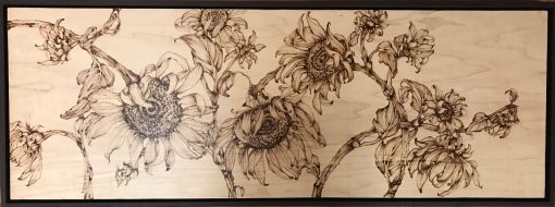 an original wood burned wall hanging of many sunflower plants. hung horizontally