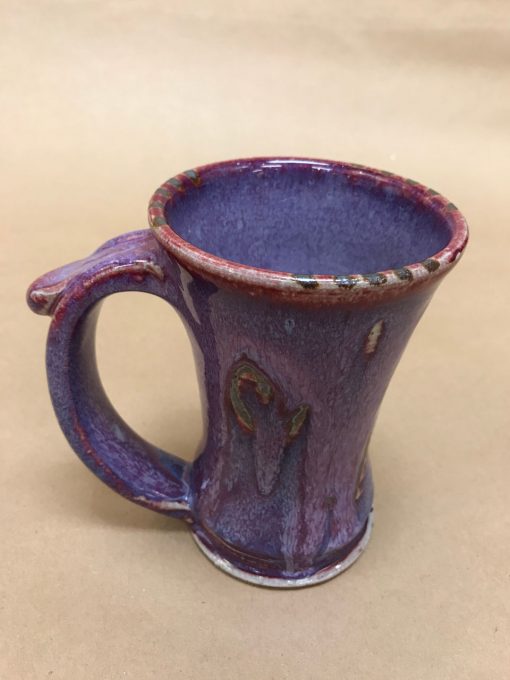 a large ceramic mug with a wide rim made up of mostly purple, violet hues