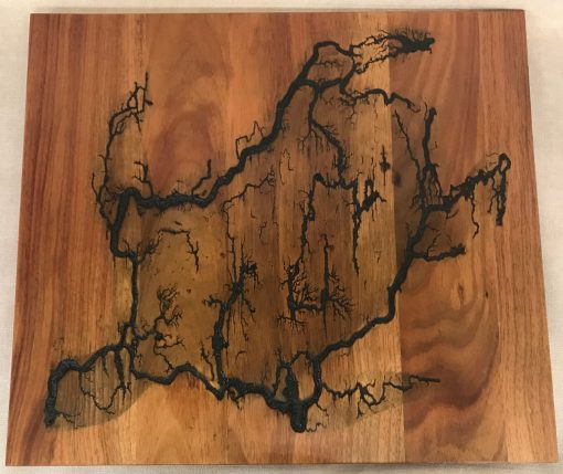 a original wall hanging made of Hawaiian Koa wood. Socked with electricity to form the shape of a Honu, Hawaiian Sea Turtle. Outline of electrical waves is black, against the wood grains.