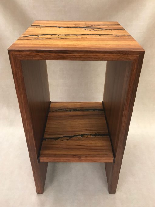 a stand, or shelf made of Hawaiian Koa and Wenge wood. Shocked with electricity to form an organic design. Front View