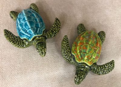 ceramic turtles with ridged shells. Shells are hand painted with various colors