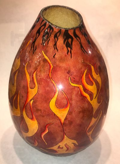 tall skinny hand painted light red terra cotta base color gourd with firey red and yellow flames with black flames at the top