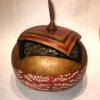 short wide round hand dyed red bottom with bubble motif tan lid with knife shaped handel and geometric design by Maui local artsit Jaz Staley
