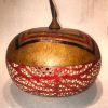 short wide round hand dyed red bottom with bubble motif tan lid with knife shaped handel and geometric design by Maui local artsit Jaz Staley