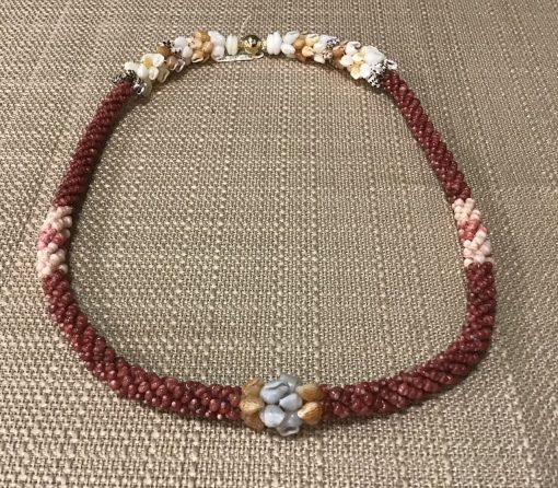 Ni’ihau lei, 19″ 4-tie Poepoe with Pikake Momi. Created by master artisan Kanani Puo.