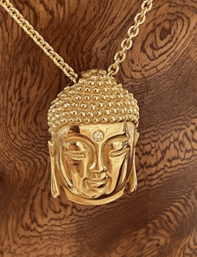 Yellow gold Buddha head on chain with small white diamond in center of forehead