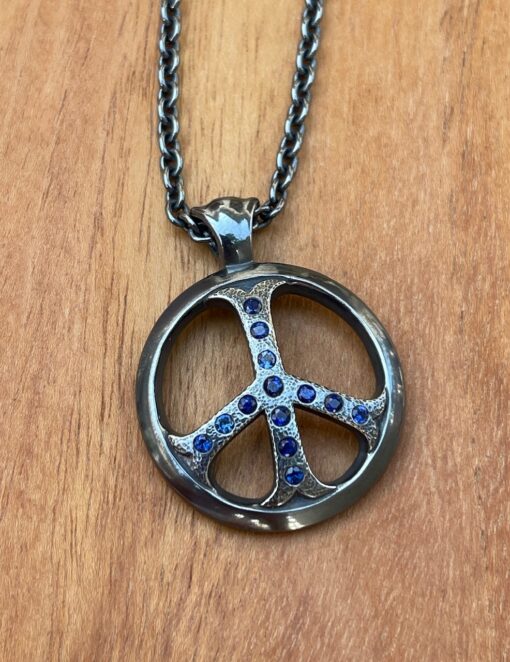 Black silver peace symbol pendant with blue sapphire gemstones on chain