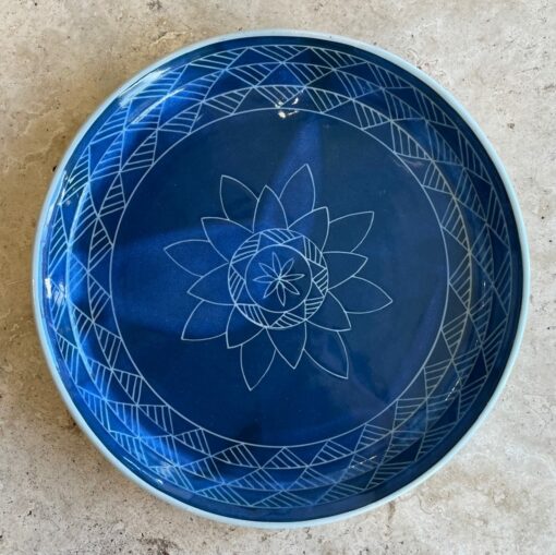 Royal blue shallow ceramic bowl with center lotus and side geometric designs